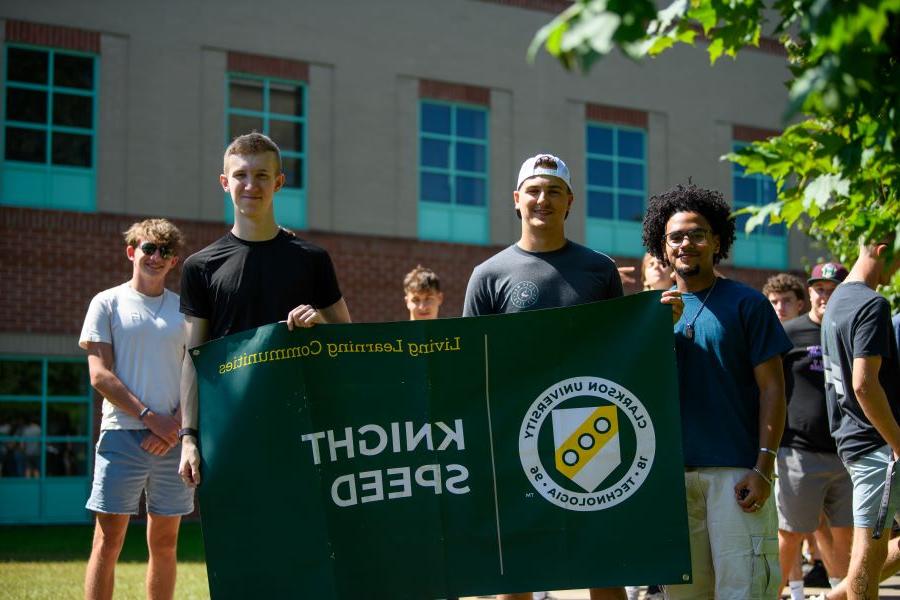 A photo of the fall 2024 knight speed living learning community holding a banner.